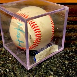 A autographed baseball with 3 signatures on it